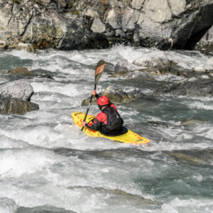 man kayaking down white water falls